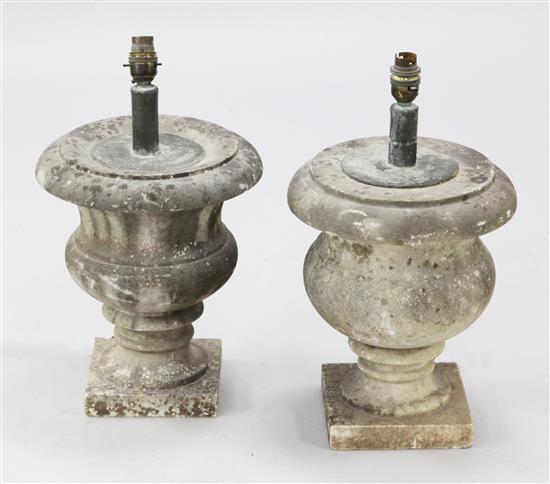 A pair of weathered marble lamp bases of urn form, height overall 17in.